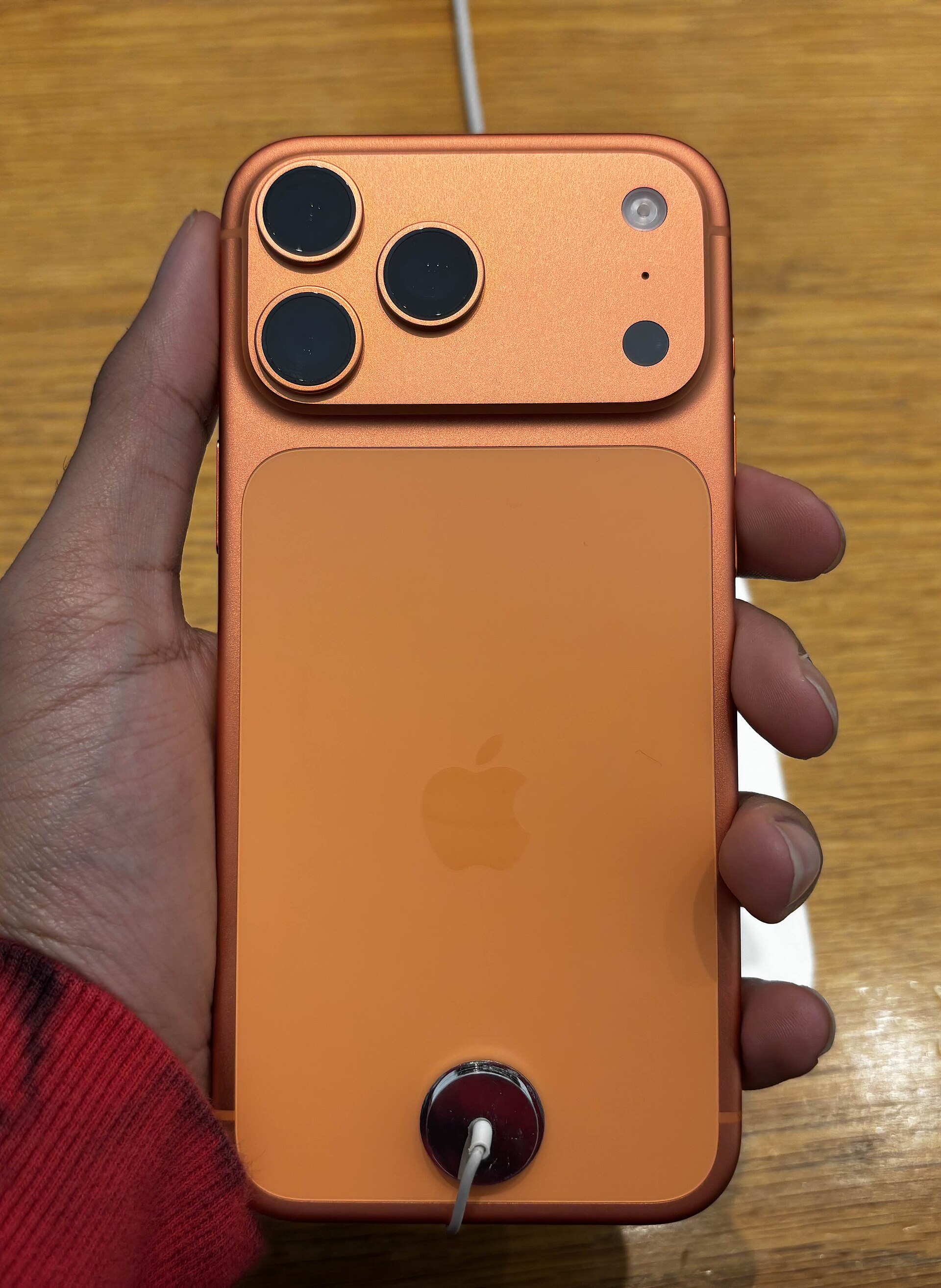 iPhone 17 Pro Max Cosmic Orange on display stand
